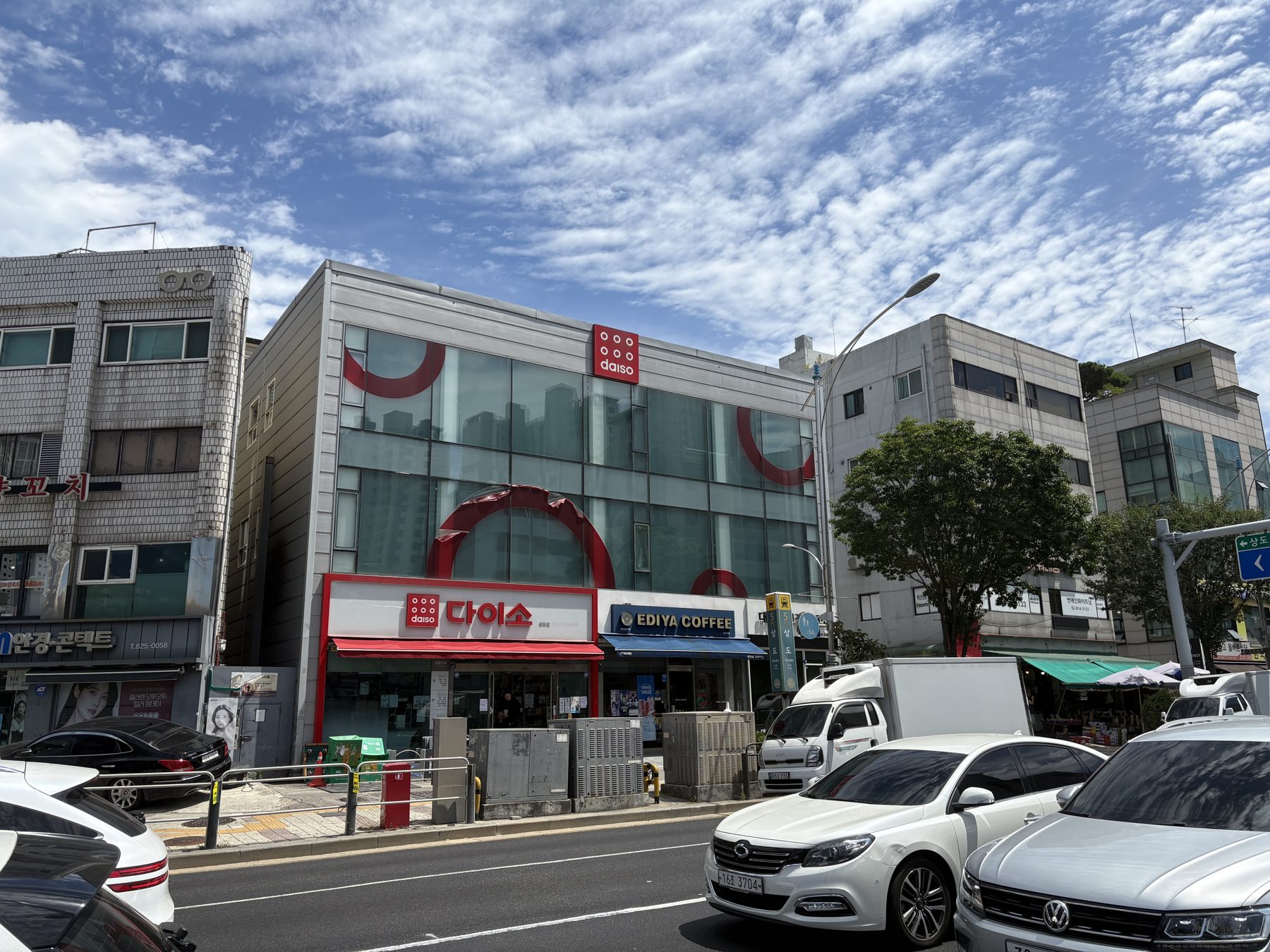 A Daiso store in Korea beneath a bright blue sky